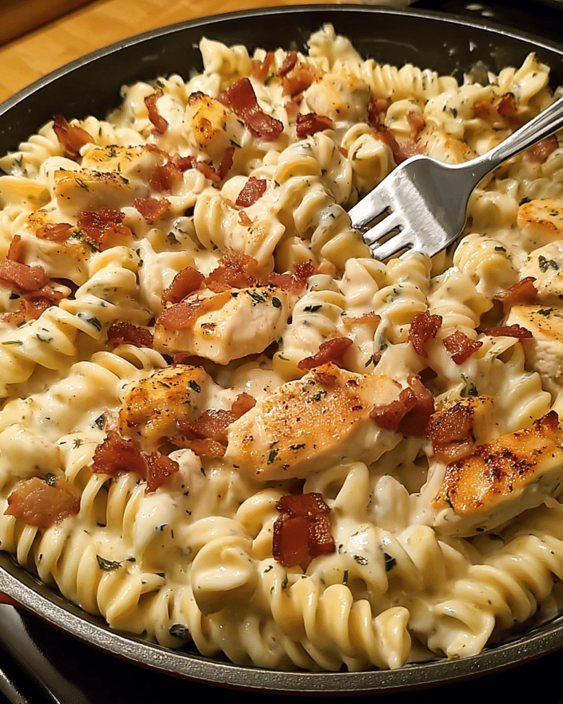 Creamy chicken bacon ranch pasta with cheese and herbs