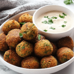 Authentic Falafel: Discover the Perfect Recipe Today! 21 a bowl of falafel balls next to tahini sauce