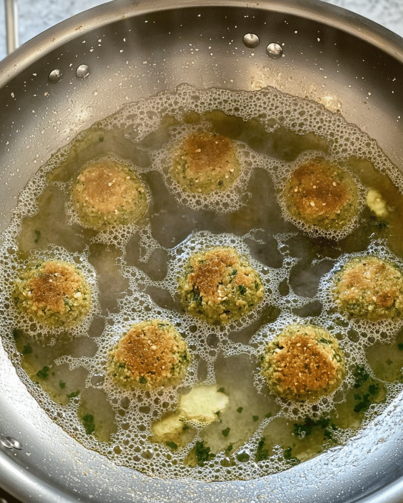 Authentic Falafel: Discover the Perfect Recipe Today! 18 falafel balls frying in a skillet