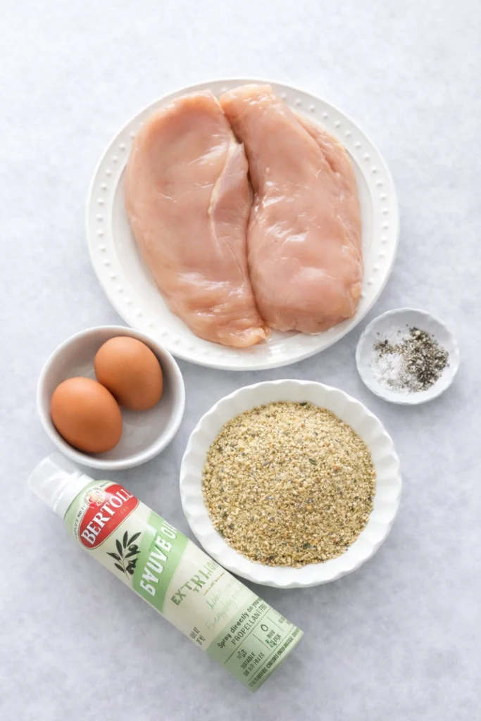 Air Fryer Fried Chicken Breast: Crispy and Delicious Recipe! 12 Ingredients for air fryer breaded chicken with labels over each ingredient.